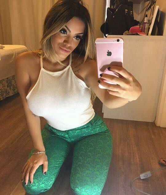 Agustina is looking sexy in white shirt and green pant or taking selfie in front of mirror