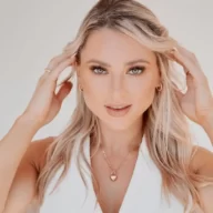 Ilana Collins posing for a pic while she is holding her hair