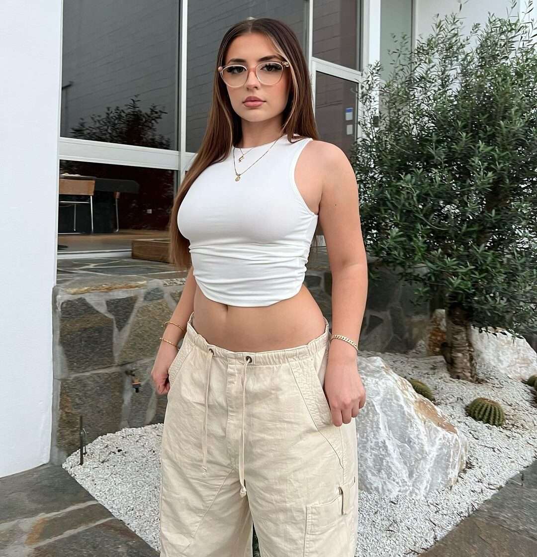 Lilith Cavaliere is wearing white shirt and trouser or standing while posing for the picture