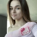 Megan Nutt is taking selfie in the sexy pink outfit while smiling towards camera
