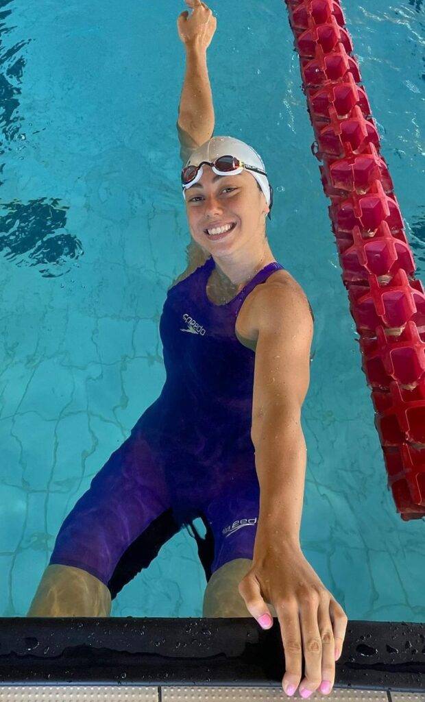 Alessandra Pace is posing for a picture during swimming as she is an Athlete.