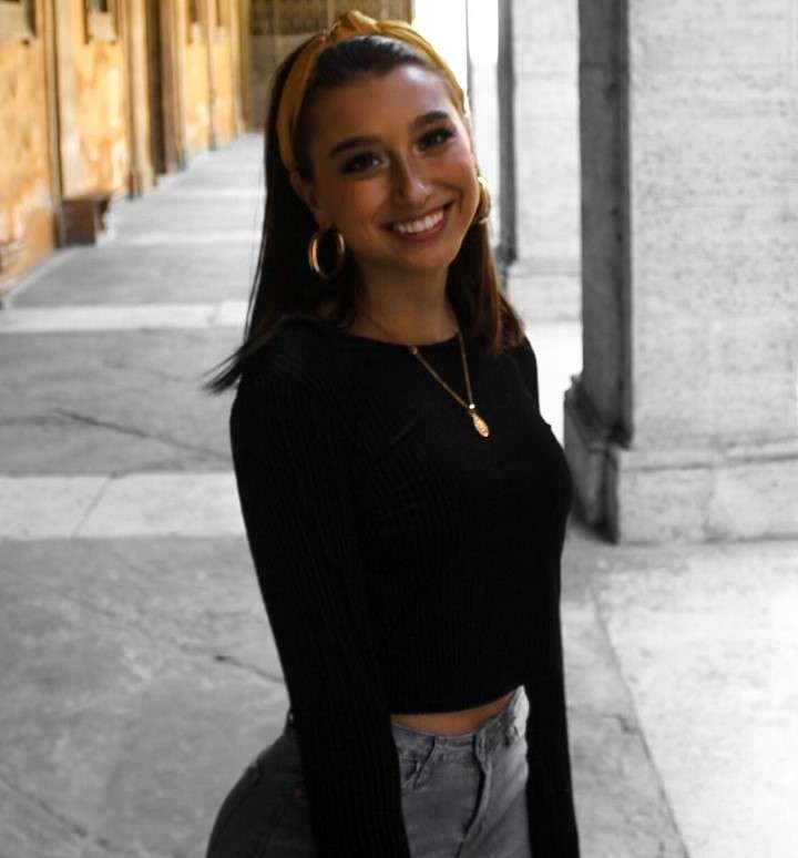 Amber Gianna is smiling and is wearing a Black shirt with pant.