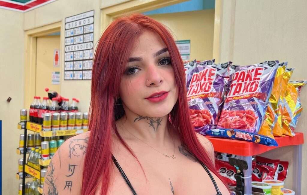 Karely Ruiz in the black sexy stripped top while taking a picture in the grocery store