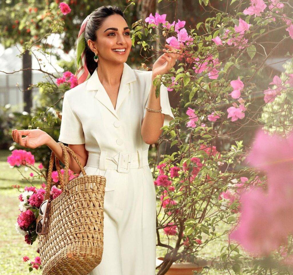 Kiara Advani in the off white jumpsuit pair with drop earrings while poses for a photo in the outdoors