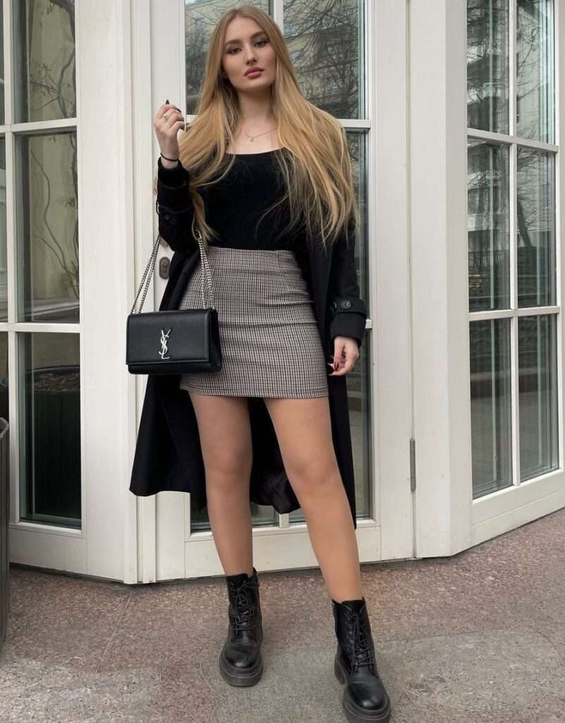 Elena Missova is posing for a picture while wearing a mini skirt.