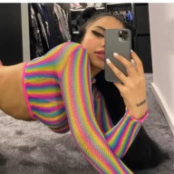 Gina Savage is wearing the multi shades sjhirt and posing while taking rhe picture