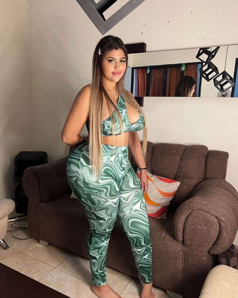 Greicy Mariana is wearing stylish green attire or smiling while posing for the picture