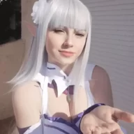Kuro Kitsune is wearing whie dress and chain or taking sun kissed while posing for the picture