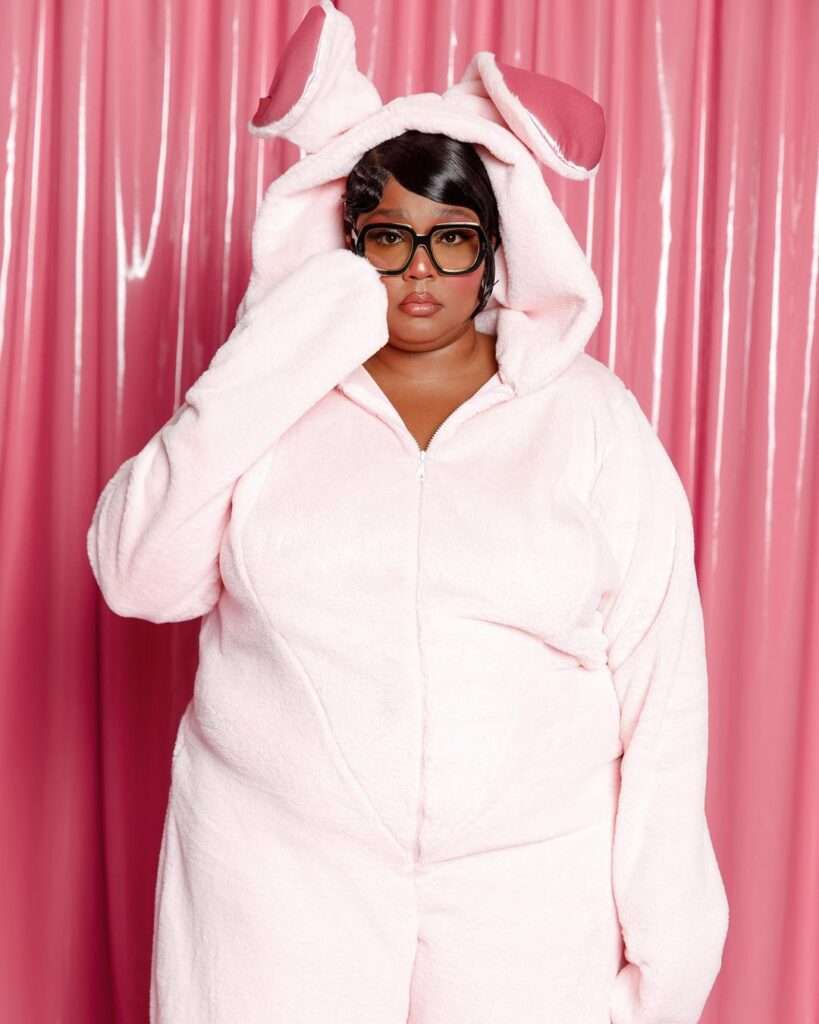 Lizzo is looking cute in white dress or wearing glasses while posing for the picture