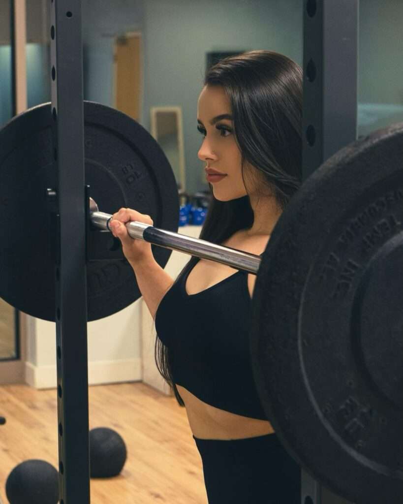 Amber Loft is training in a gym and is lifting the weight as she is a fitness model.