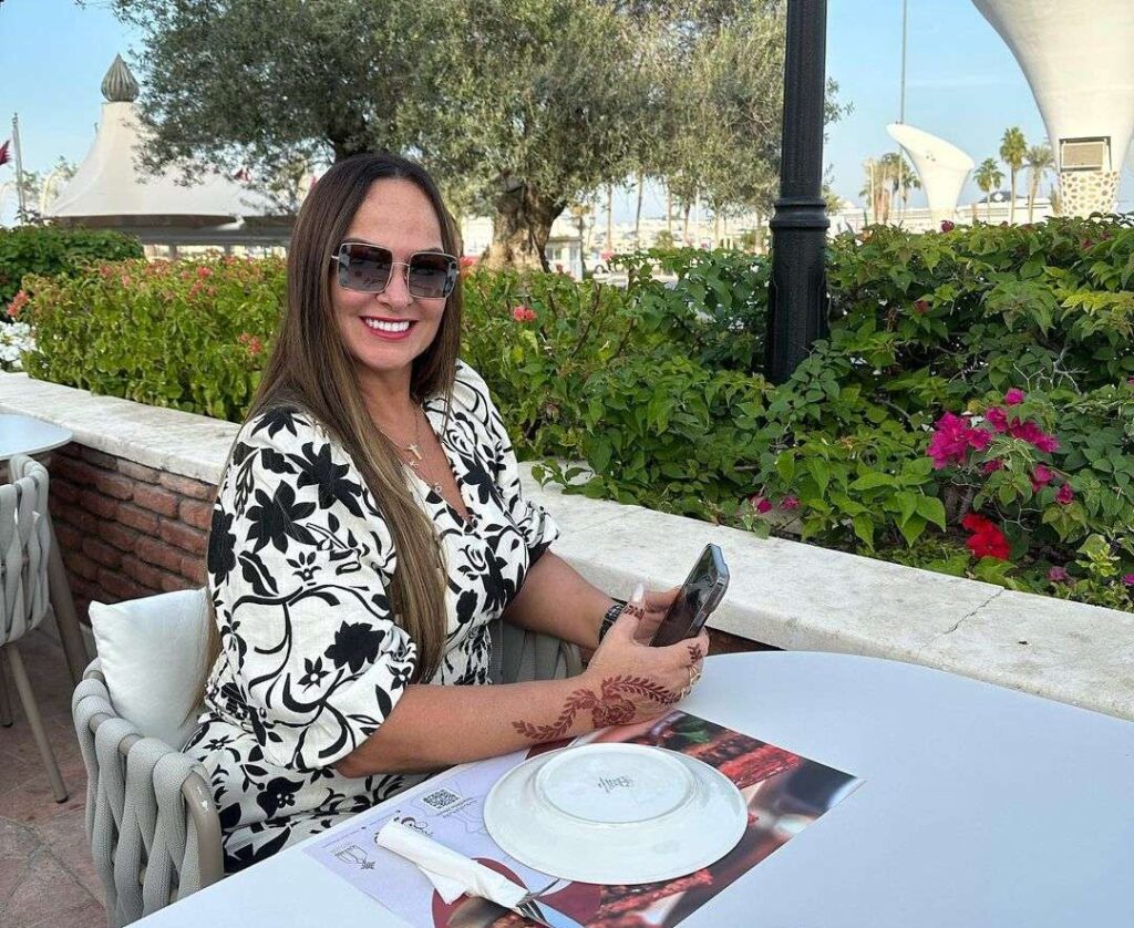 Nadine Gonçalves in the white and black printed outfit pair with black goggles while smiling towards camera