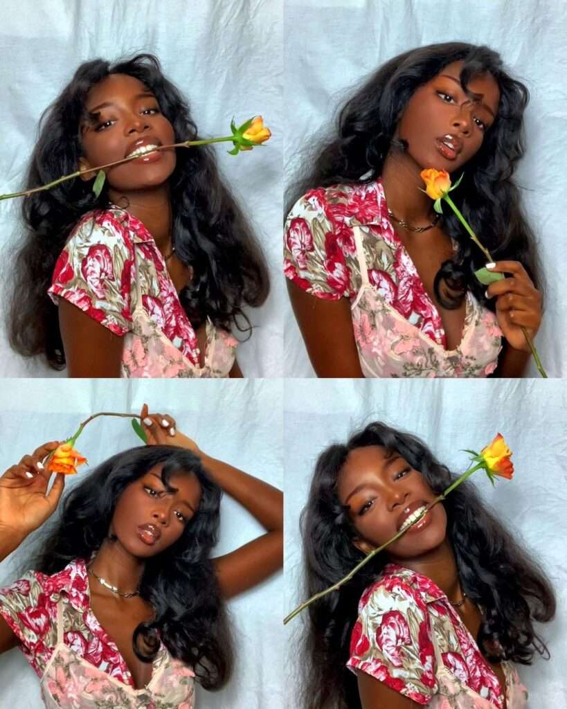 Queenblackpanther is looking hot and sexy while she is holding a rose with her mouth.