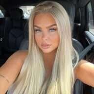 Lily Adelinaa is wearing grey outfit and sitting in the car and posing while taking the picture