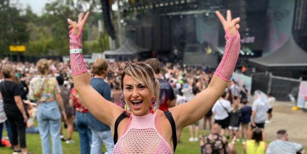 Bec Kaiser in the pink sexy outfit pair with white joggers while poses for a photo