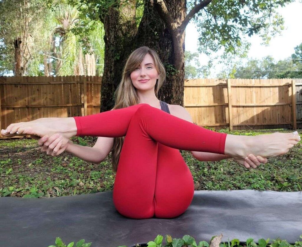 Jamie Marie in the black tank top shirt pair with red leggings while smiling towards camera