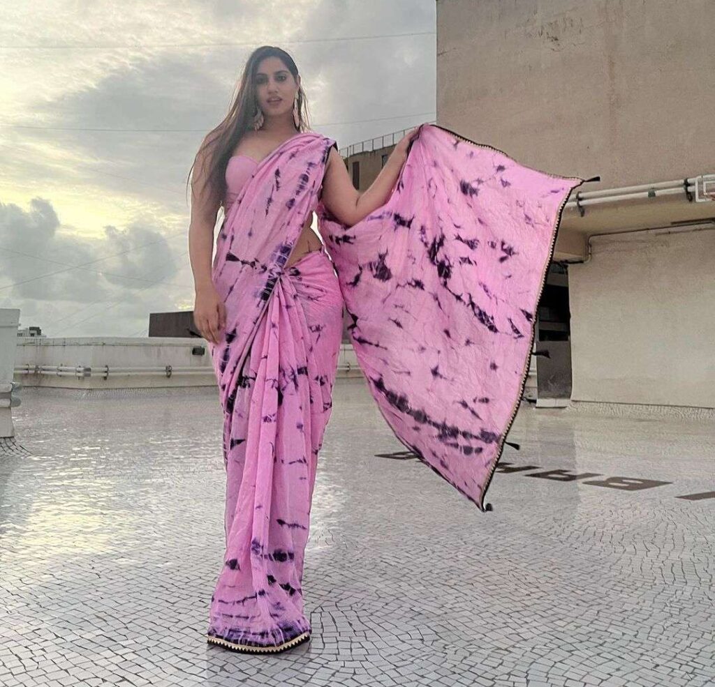 Seerat Luggani in the pink tie and die saree while poses for a photo in the outdoors