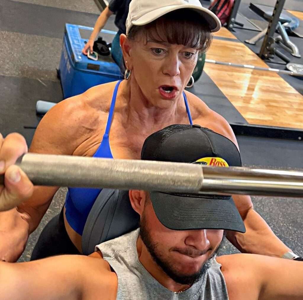 tk_fit in the blue strapped top pair with grey cap while giving training in the gym