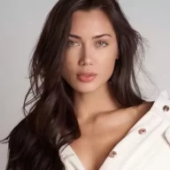 Georgina Mazzeo is wearing white dress or looking gorgeous or posing while taking the picture