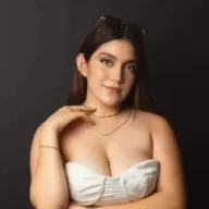 Valeria Alcala is wearing white shirt and black trouser or smiling while posing for the picture