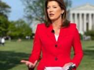 Norah O'Donnell is looking beautiful in red coat or holding the papers while posing for the picture