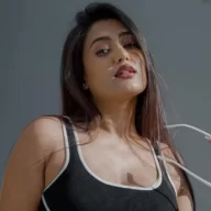 Gima Ashi in the sexy black and white outfit pair with long boots and matching glasses