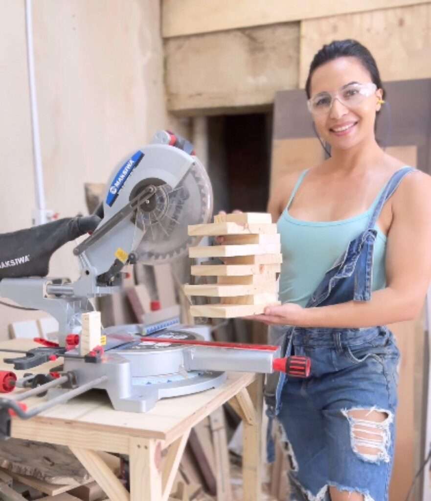 Sofia Ansari in the blue strapped top pair with jeans while holding a wooden product in her hand