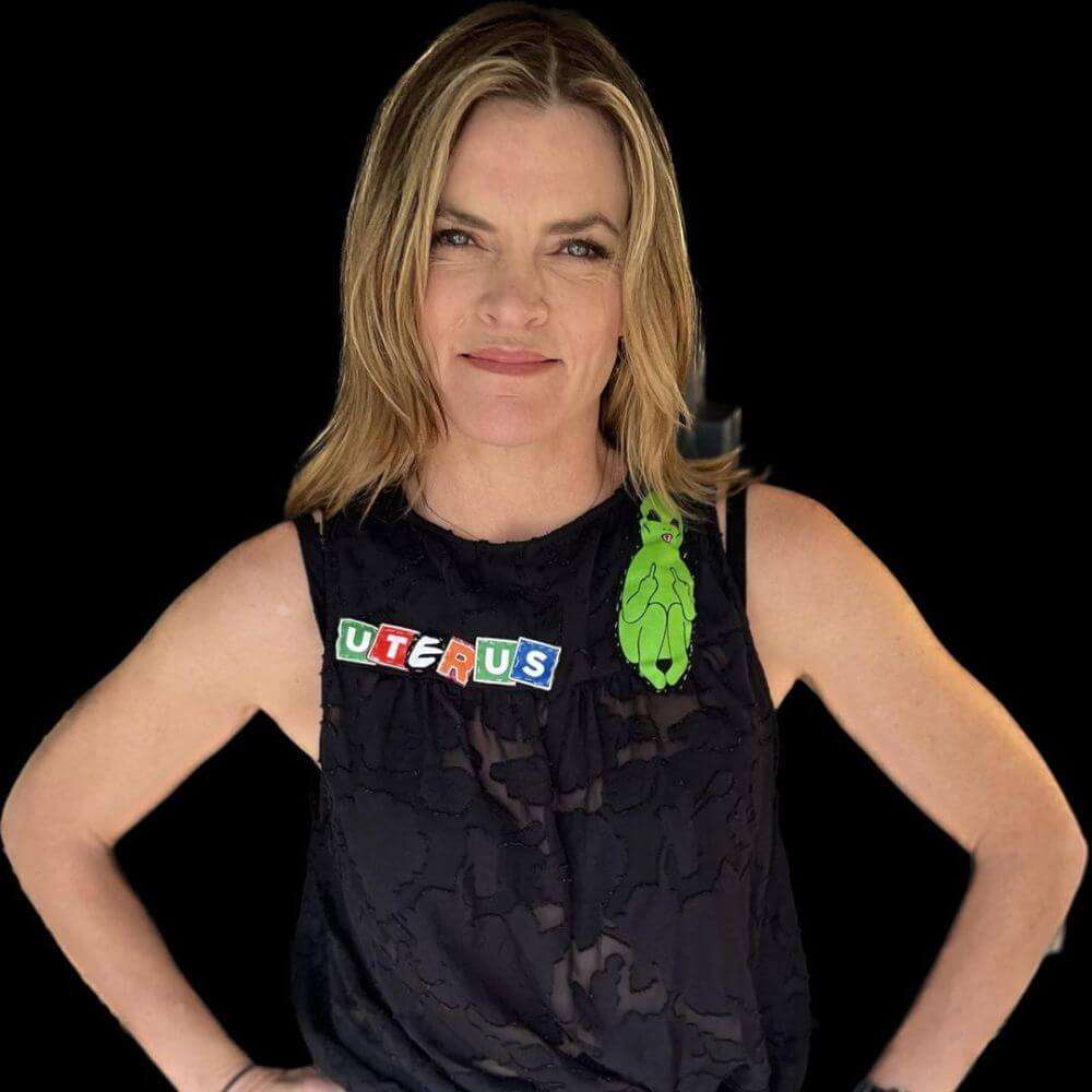 Missi Pyle is wearing black shirt or smiling while posing for the picture