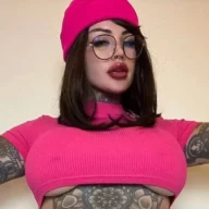 Charlotte Emerson is wearing pink shirt cap and grey trouser or posing while taking the picture