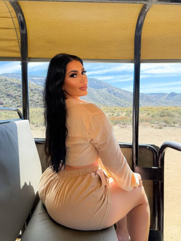 Sammyy02k: Wiki, Biography, Age, Boyfriend, Family, Height, and Facts 12 Sammyy02k sitting inside a safari vehicle wearing a soft beige outfit, with desert mountains in the background.